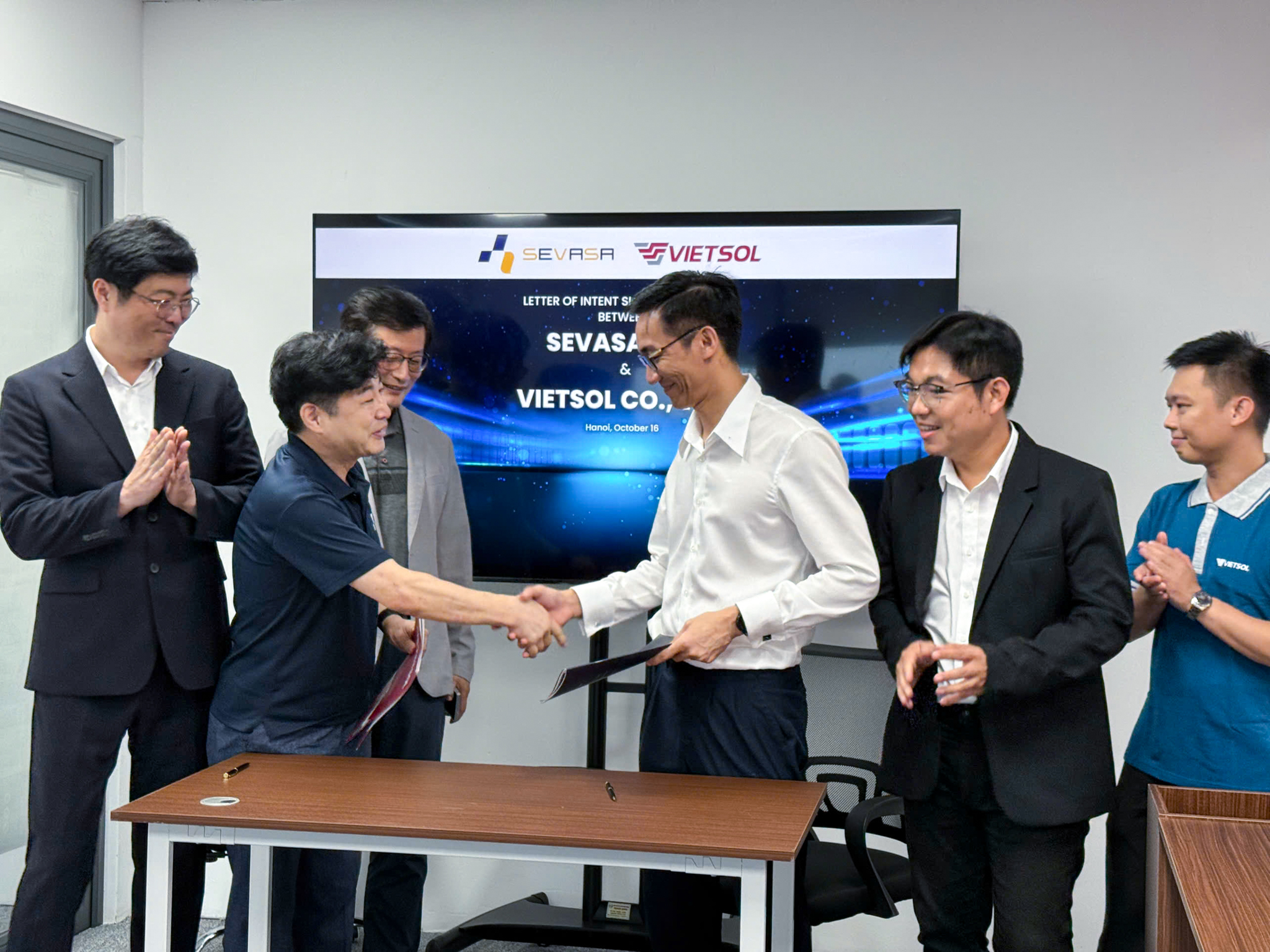 Vietsol and SEVASA teams pose together after signing partnership agreement on Smart EV Charging.
